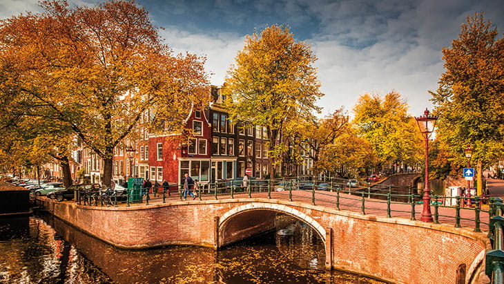 Amsterdam canal surrounded by autumn colours and trees, Netherlands